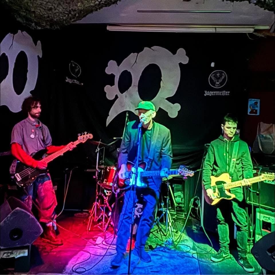 Chevette on stage, Brian at the microphone with bass and guitar either side
